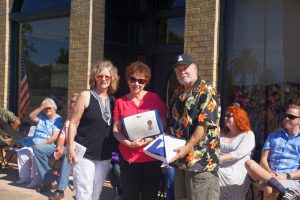 On behalf of Texas State Representative, Dennis Bonnen, District 25, Barbara Reece, District Director for State Representative Cindy Burkett, District 113, presents Paul and Donna a Texas Flag that was flown over the Texas State Capitol. A great honor indeed.